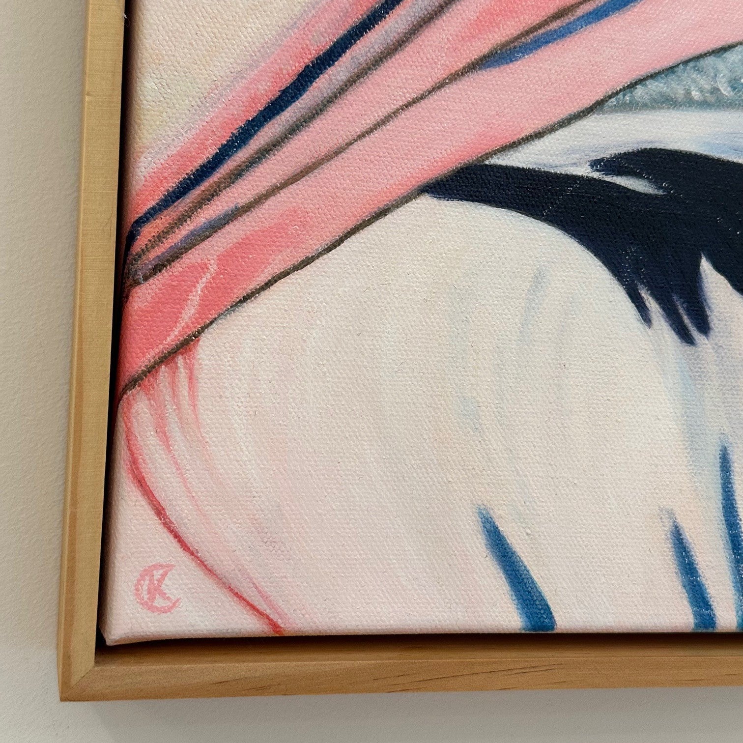 Framed closeup of the artist signature of a pelican painting with a  light background